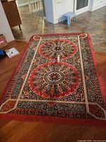 Full view of tapestry rug on floor displaying overall pattern and size