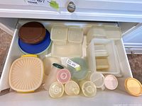 drawer view showing mixed Tupperware pieces with lids