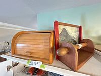 Bread box, tray, and paper towel holder grouped on shelf