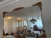 Full view of mirror hanging on wall showing entire frame and reflection