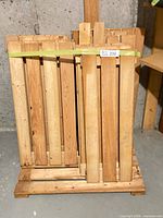 Front view of stacked pine boards secured with strap on pallet