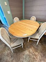 Overall view of oval pedestal dining table with four chairs