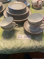 Stacked plates with two teacups showing pattern and count
