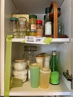 Full view of cupboard shelves showing majority of containers