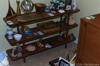Three photos of a retro wooden shelving unit placed against a wall, showing the unit fully assembled with various decorative items on each shelf.