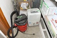 Vacuum and dehumidifier side by side on floor, showing general condition and setup