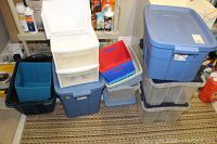 Photo showing full grouping of storage bins, milk crates, baskets, and storage drawers stacked and grouped together.
