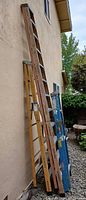 All three ladders leaning against wall