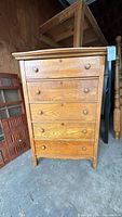 Front view showing five drawers with wooden knobs