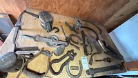Overhead shot of entire lot showing pulley block, pulley wheel, blades, hooks, cow bell and hardware