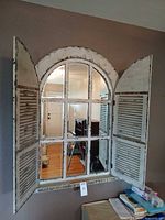 Mirror front with shutters open showing multi-pane glass
