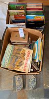 Two boxes of assorted books with two Waverley Novels in front