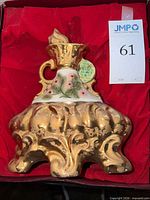 Decanter in red satin-lined box, hang tag visible
