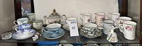 Shelf view of all teaware, mugs, miniatures