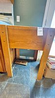 Front view of butcher block table showing legs and frame