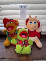 Front view of all three plush toys together