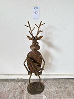 Full view of metal reindeer figurine holiday card holder with antlers and tree coil