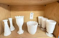 All seven milk glass pieces on shelf