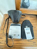 Overall lot with Minolta leather case, Polaroid printer, black zip case and strap