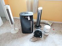 All five items grouped: DeLonghi AC, two tower fans, desk fan, air purifier, exhaust hose and adapter visible
