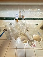 Full lot showing pitchers, decanters, stemware, glass vase and porcelain rose pieces