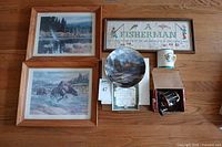 Group shot showing both framed prints, cross-stitch, Kinkade plate, mug, Penn reel with box