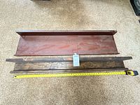 Both wall shelves with measuring tape showing 48 in length