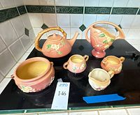 Full set of six Apple Blossom ceramic pieces on stovetop