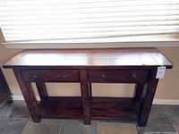Front view of console table showing drawers, shelf, overall structure and finish
