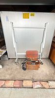 Table folded, metal frame, basket with accessories visible