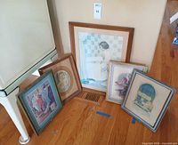All five framed prints leaning against wall for group overview