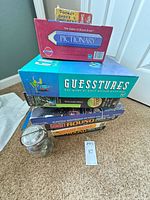 Stack of games, puzzles and marbles jar