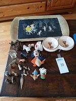 overall view of tray, bowls, figurines, pin cushion and glass piece on table
