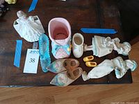 Top view of entire lot showing all decorative shoes, planters and figurines