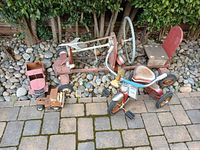 Group shot of tricycle, pedal car frame, two toy trucks