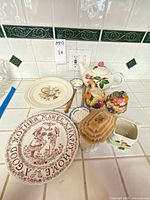 Full grouping of tea set, plates, spoons, jar and bowl displayed on counter