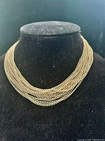 Necklace displayed on bust showing layered chains