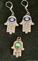 Front view of earrings and pendant showing design, stones and colours