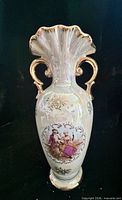 Full front view of vase showing handles, flared rim, pedestal base, transfer scene, and iridescent glaze