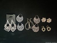 Overview of all six earring pairs on black background