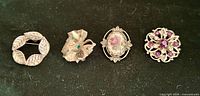 Front view of all four brooches