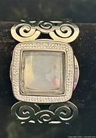 Front view showing cabochon, CZ border, and scrollwork cuff design