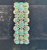 Front view showing turquoise carved rose cabochons across entire bracelet