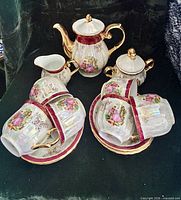 Full set showing teapot, creamer, sugar bowl, stacked cups and saucers