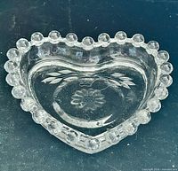 Top view of heart-shaped dish showing hobnail rim and etched cornflower pattern