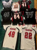 Overview of eight jerseys laid out showing team names and numbers
