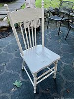 Full view of white wooden chair showing design and overall condition