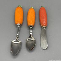 Front view of the three utensils showing ceramic handles and stainless heads