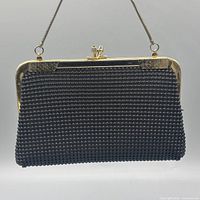 Front view showing beaded exterior and gold-tone frame