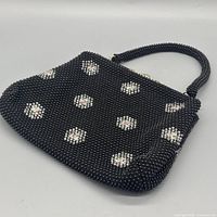 Front view showing beaded floral exterior and handle
